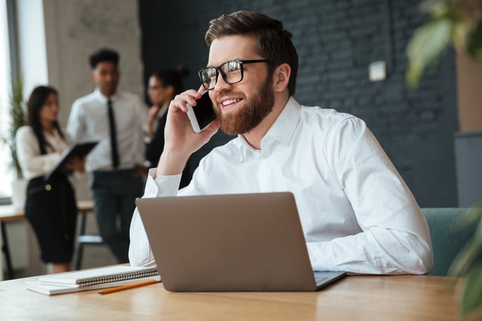feliz-joven-empresario-caucasico-hablando-telefono-movil